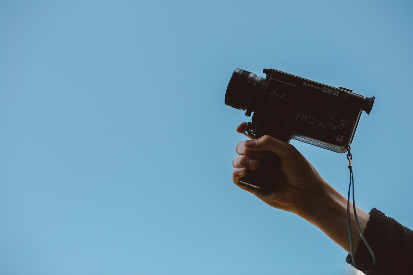 Hand holding a vintage cine camera